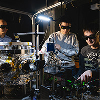 Prof. Tongcang Li (left), Dr. Yuanbin Jin (middle) and Kunhong Shen perform experiments with levitated and rotating fluorescent diamonds at Purdue University.