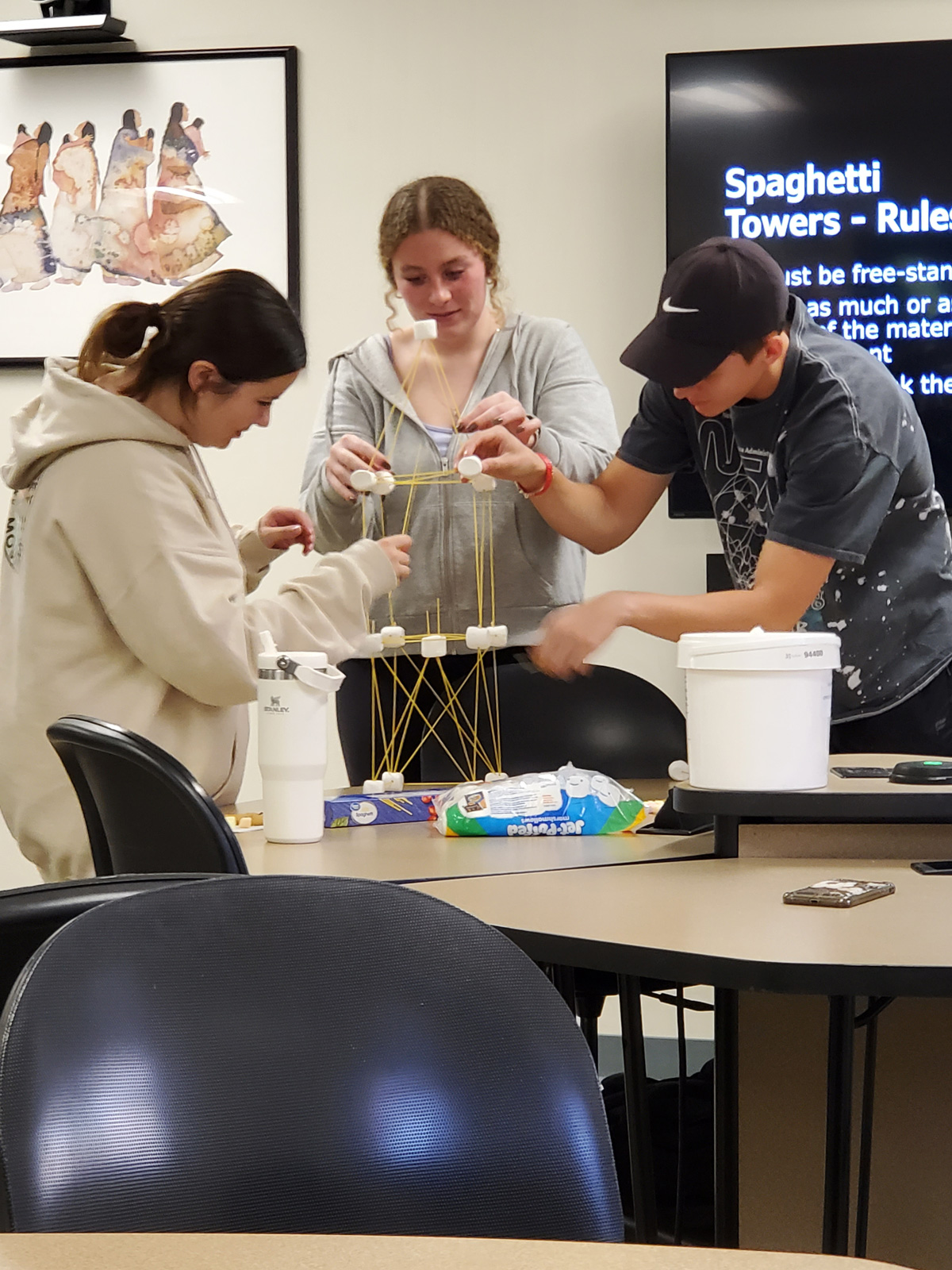 Students building a spaghetti tower.