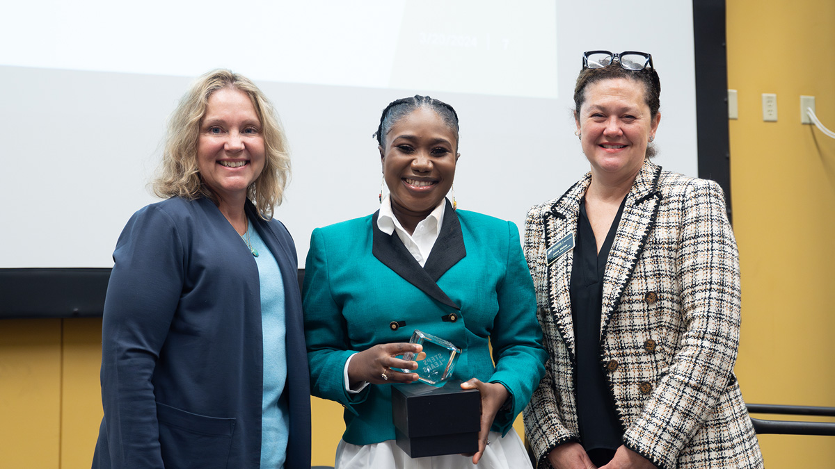 Mary Busayo Oluyemi posing with her award alongside Dr. Beth McCuskey and Dr. Heather Servaty-Seib