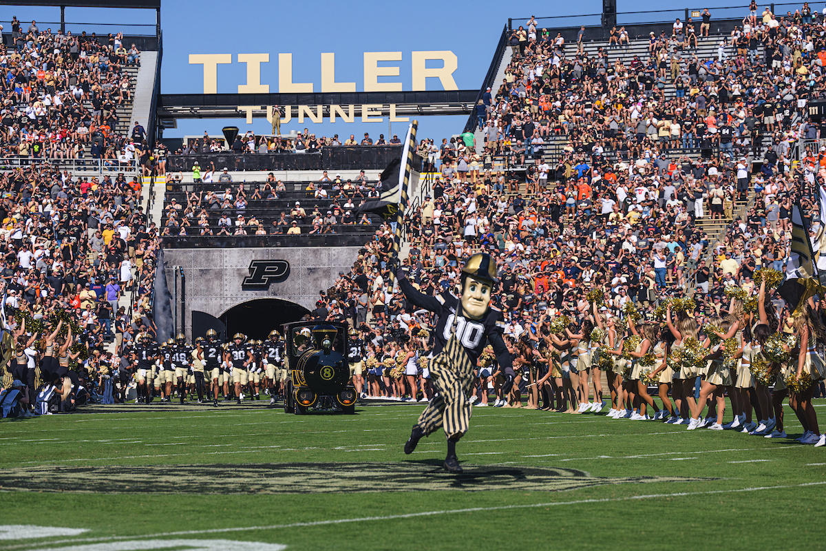 Image showing man with whiteboard marker writing, facing towards students