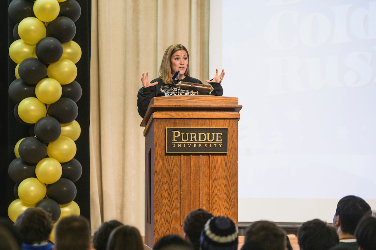  Purdue Orientation Programs Sr. Assistant Director, Maggie Smith, stands at a podium during Boiler Cold Rush