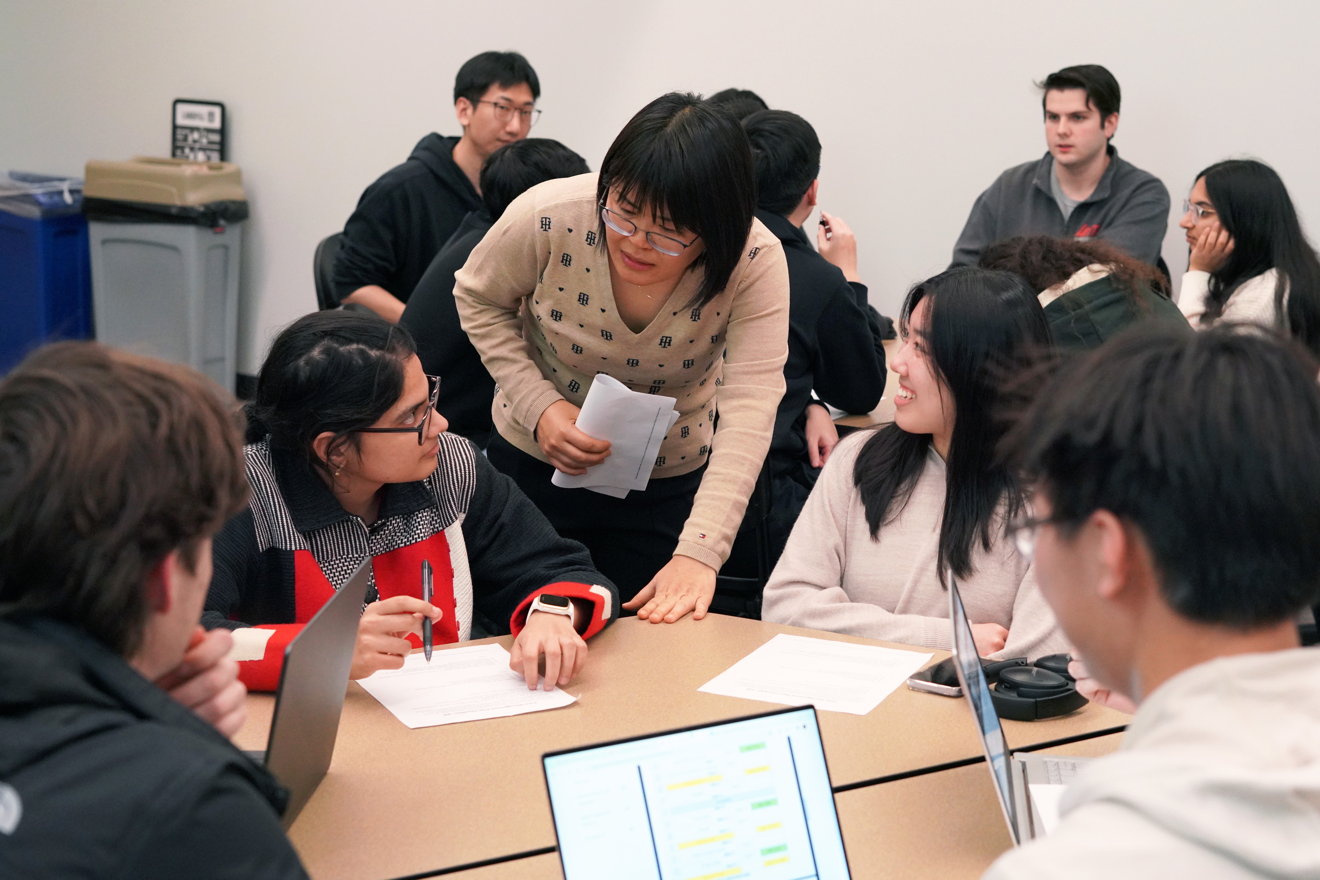 Undergraduate researchers Annapoorna Prabhu (front left) and Ruth Sugiarto (front right) interact with Wei Zakharov (center), associate professor and engineering information specialist. Graduate mentor Zichen Miao (back left) and undergraduate researcher Gaetano Iannotta (back right) look on.