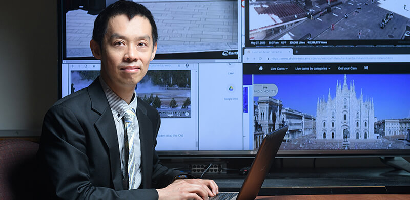 Yung-Hsiang Lu with screens of live images