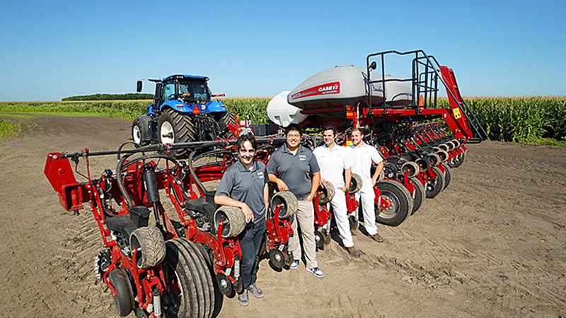researchers and tractor in field
