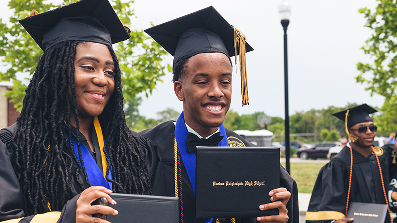 Students holding diplomas