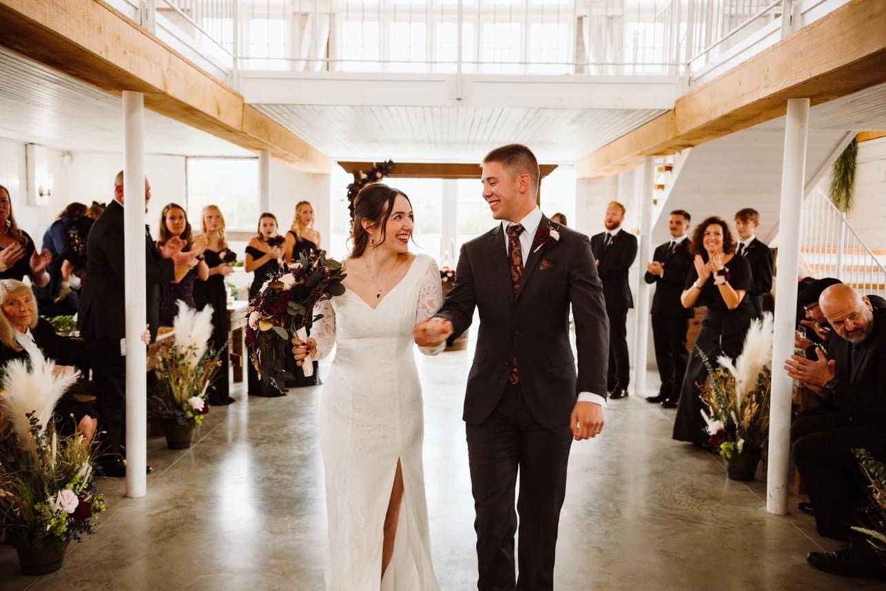 Brayden and Janette walking down the aisle together after getting married.