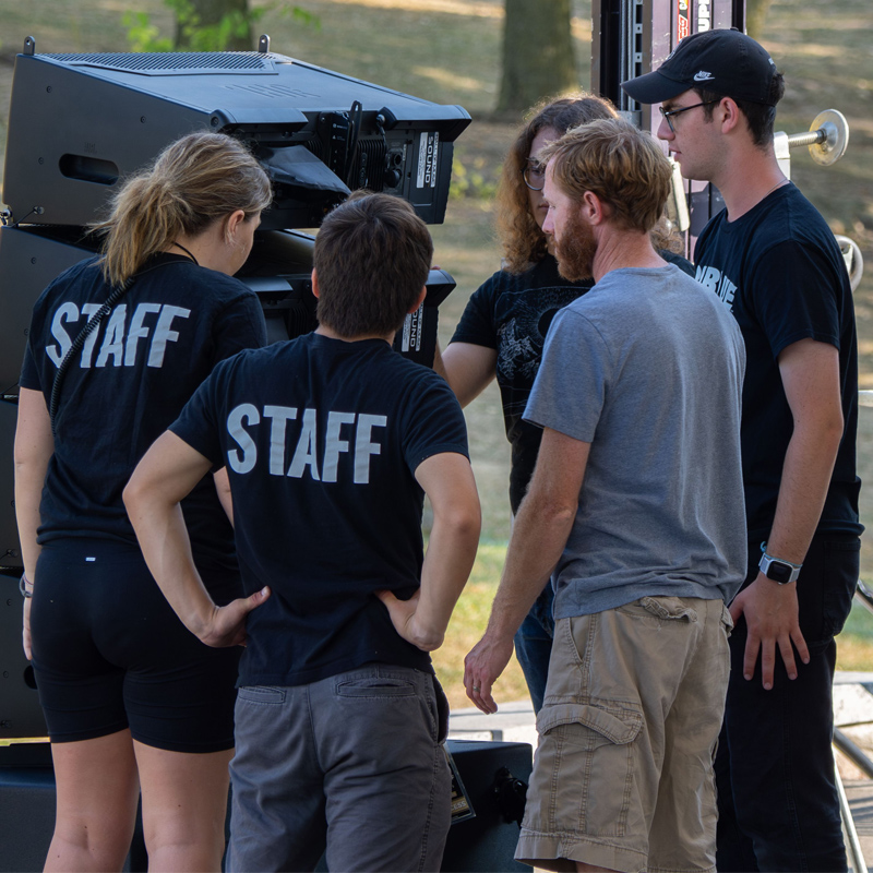 A photo of the staff fixing a speaker 