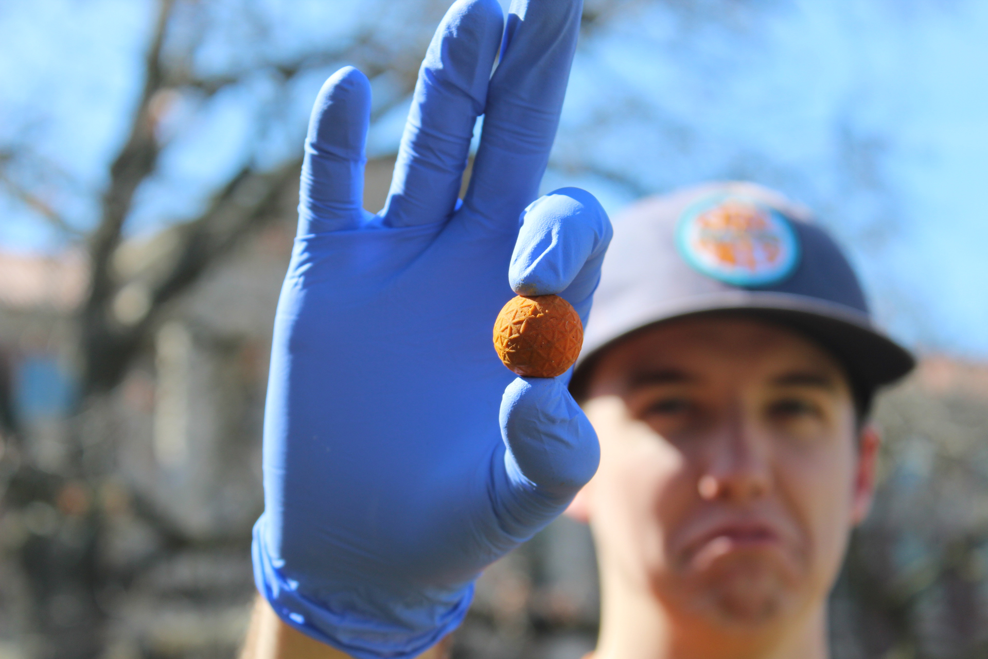 A photo of a Purdue green initiative club member holding a ball of trash