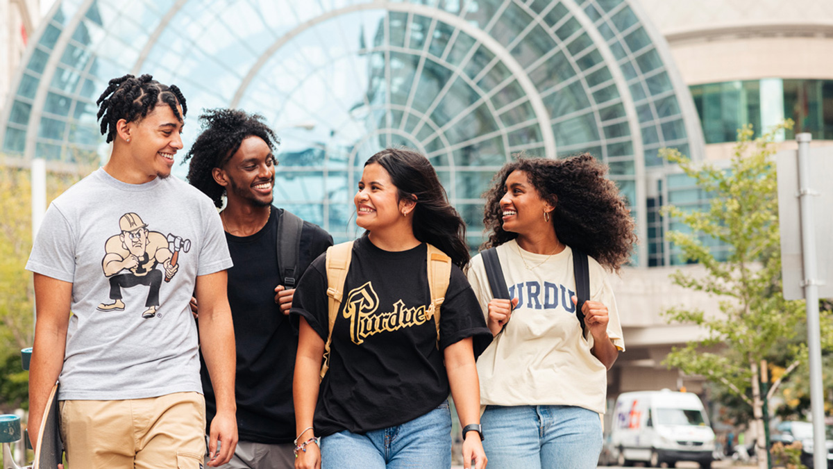 A group of students walking and laughing together.