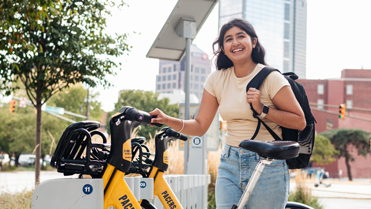 A student preparing to use a Bikeshare bicycle.