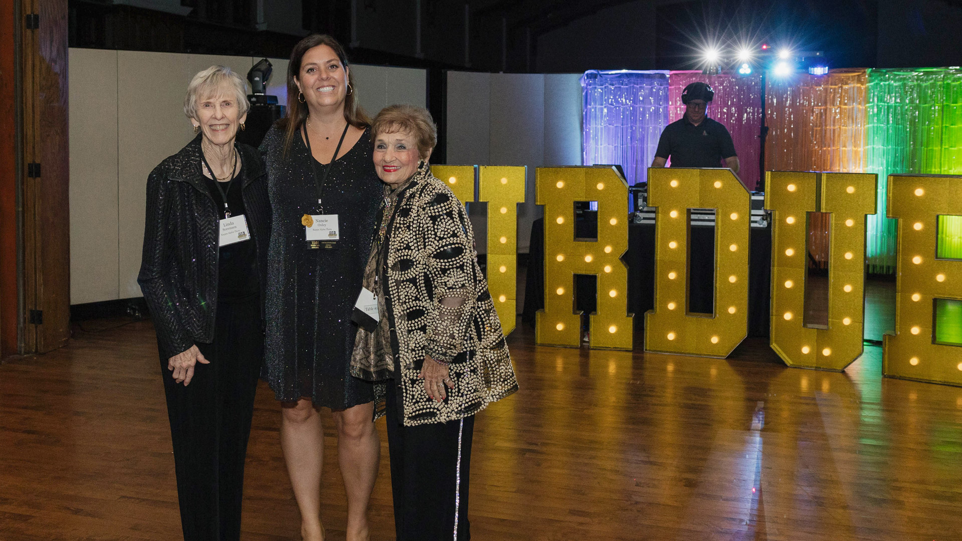 Sheila Klinker, honoree pictured with neon Purdue letters and friends.