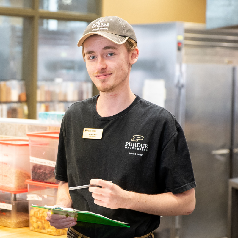 A Purude Dining & Culinary student employee helping a customer