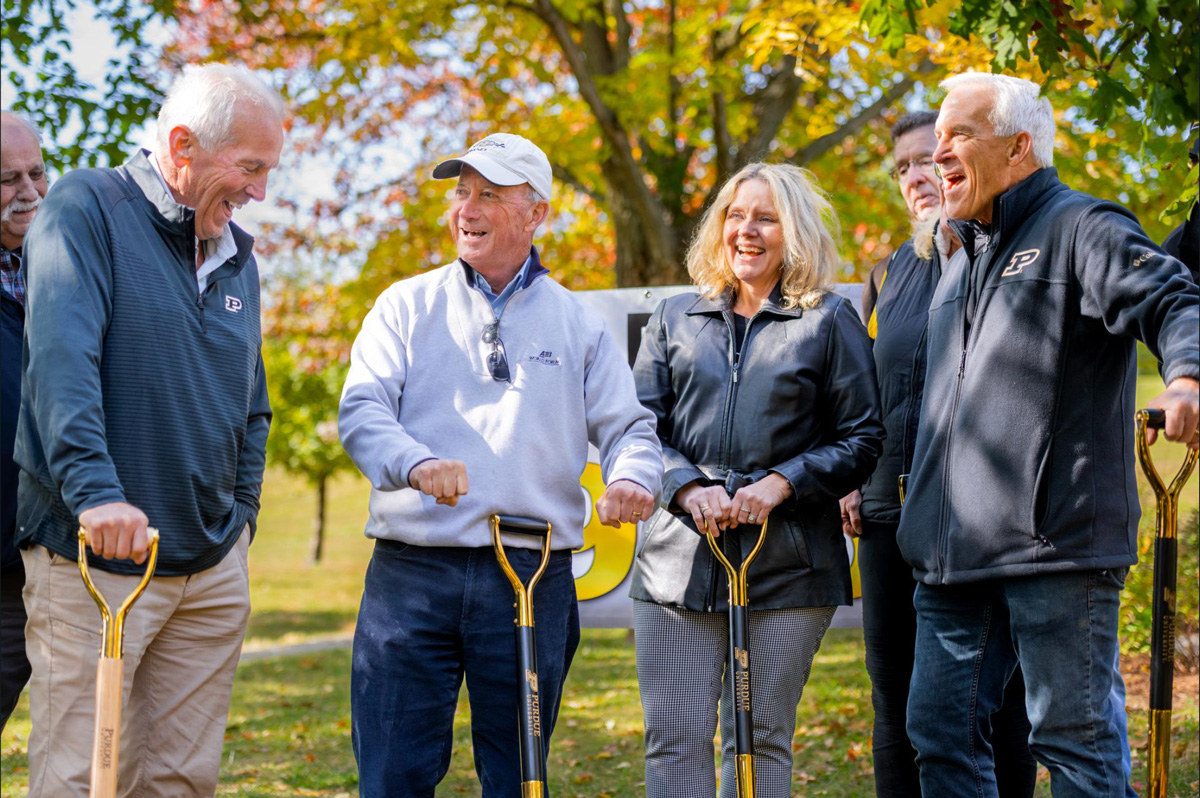 Mitch Daniels and Beth McCuskey laughing with others during the Friendship Grove dedication ceremony.