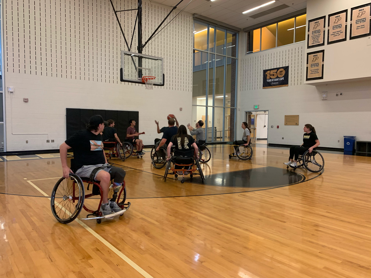 People playing wheelchair basketball.