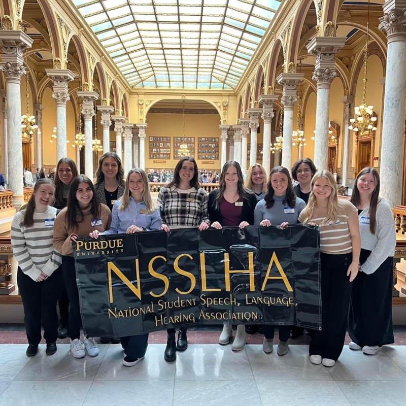 Students holding a banner for NSSLHA